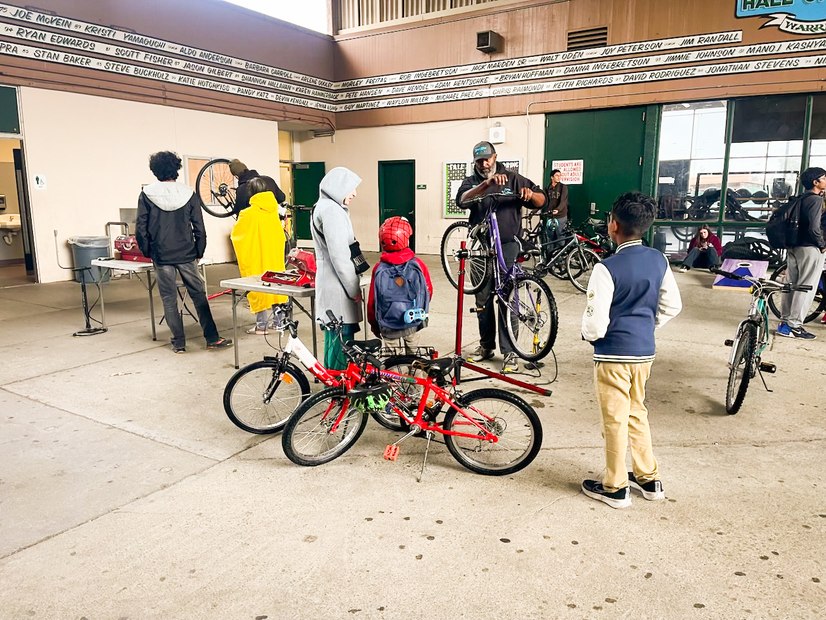 Students at Bike Mobile repair station with Alameda County Schools