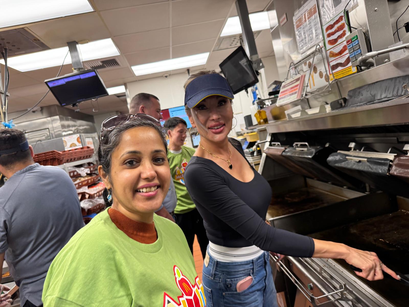 Anusha and Principal Amy Perez flipping burgers